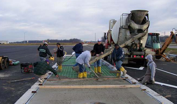 Concrete is poured into the deck of a concrete weighbridge at installation